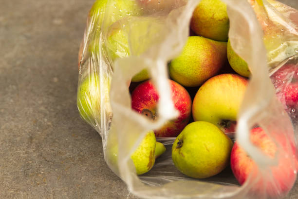 istock Fresh Domestic Apple in Transparent Bag on Table 1027140970