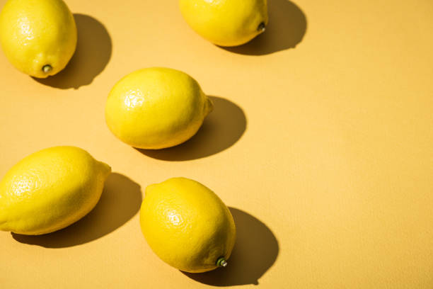 istock fresh lemons on yellow minimalistic background with copy space 1027145144