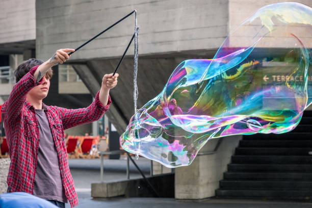 A soap bubble street performer around Southbank area in London London, UK - July 19, 2018 - A soap bubble street performer around Southbank area bankside photos stock pictures, royalty-free photos & images