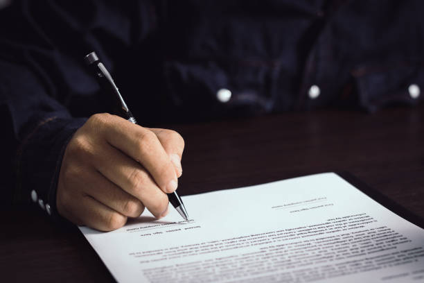 istock Hand writing and sign on paper contract 1027149998