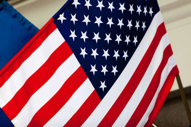 istock The US flag hang on the flagstaff. Horizontal shot. 1027152442