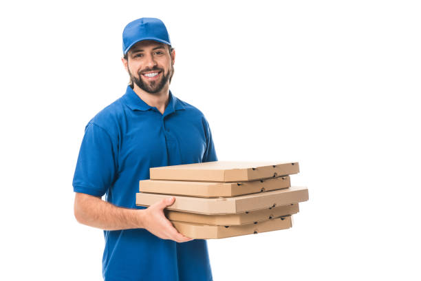 istock happy delivery man holding boxes with pizza and smiling at camera isolated on white 1027153936