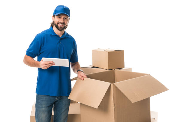 istock young delivery man using digital tablet and smiling at camera isolated on white 1027154266