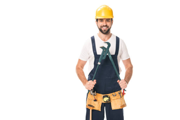istock handsome happy repairman in tool belt holding adjustable wrench and smiling at camera isolated on white 1027156696