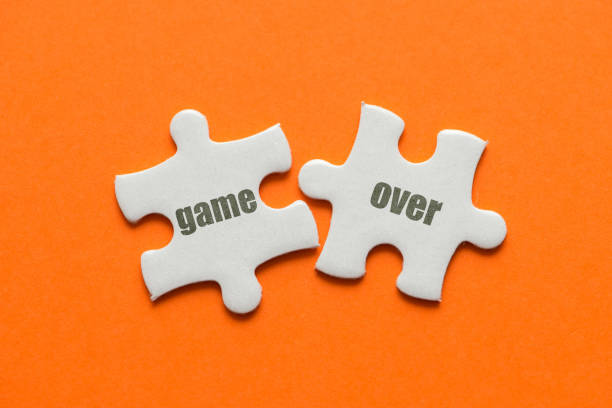 istock Two white details of puzzle with text Game Over on orange background, close up 1027161080