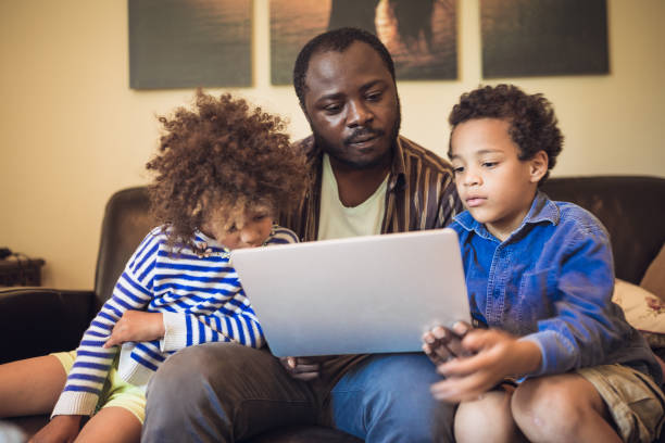 istock Father and his children using a laptop 1027161310