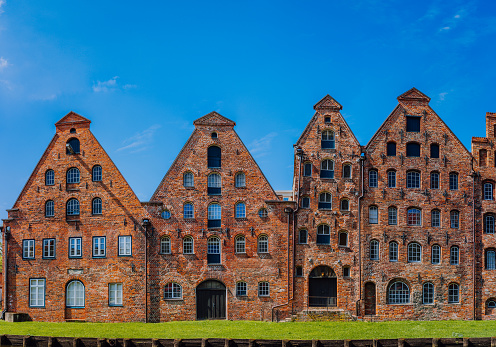 The salt storehouses, historic red landmark brick buildings on the Upper Trave river in Luebeck, Schleswig-Holstein, northern Germany.