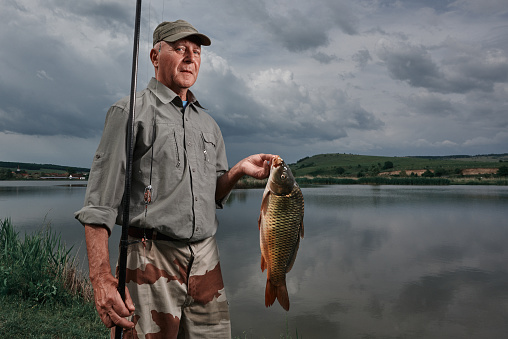 lifestyle shot of senior man at retirement enjoying fishing.