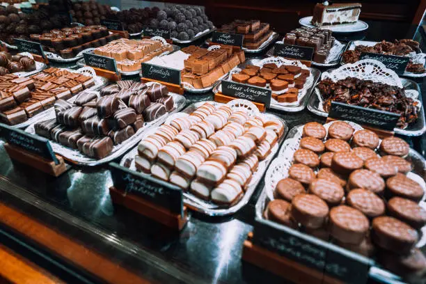 Photo of Lubeck traditional marzipan chocolates on plates in a tourist shop. Schleswig-Holstein, north Germany