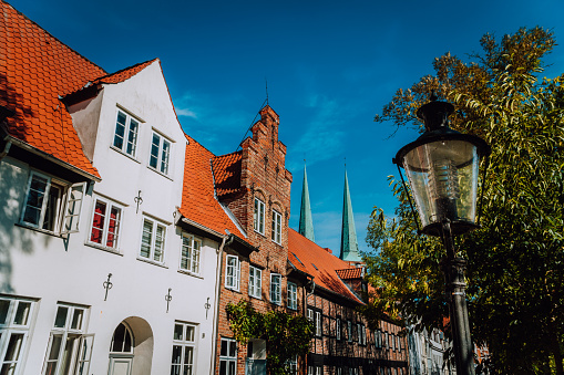 Half timbered and white chalk houses and street lantern in the old center of Luebeck in Schleswig-Holstein, northern Germany.