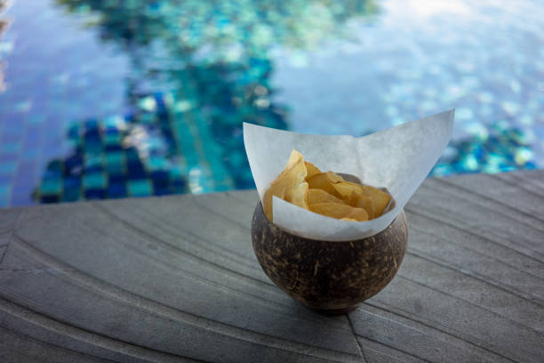 istock chips for snack in bowl with pool water background 1027166898