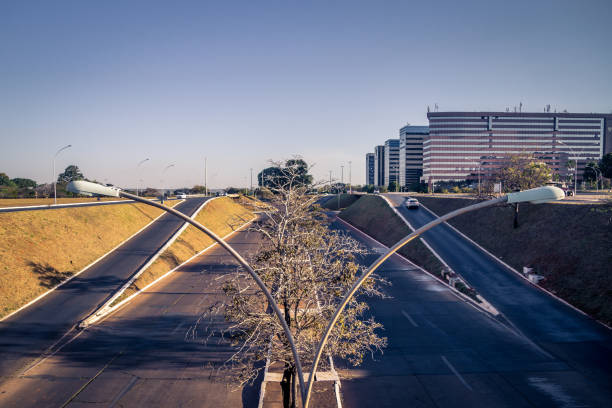 Front view from a empty road in Brasília Brasília, DF, Brazil - August 12, 2018: Front view from a ordinary street in Brasília. This shoot was in a weekend in the end of the day city zoom out stock pictures, royalty-free photos & images