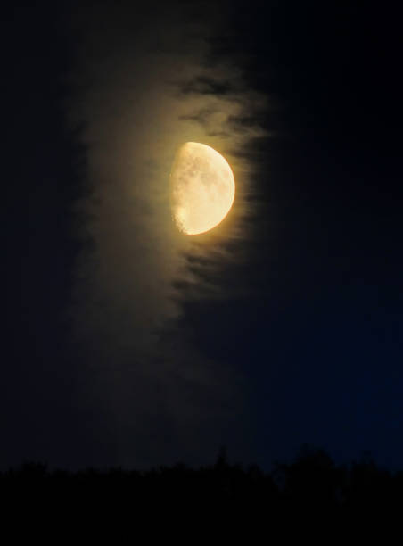 istock glowing yellow half moon illuminating clouds against a black sky 1027175716