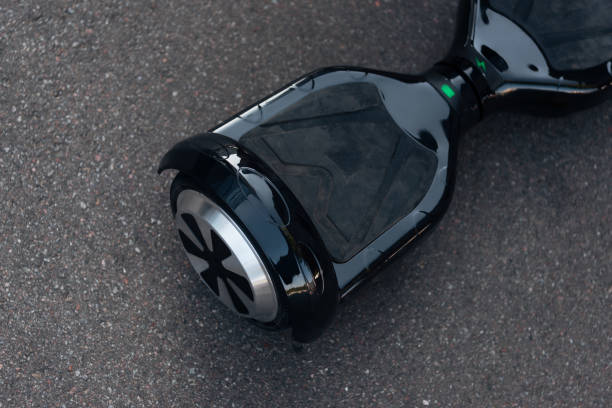 close-up view of black self-balancing scooter on street close-up view of black self-balancing scooter on street hoverboard stock pictures, royalty-free photos & images