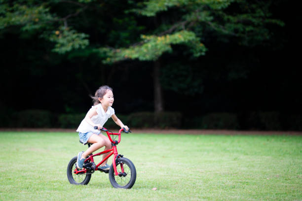 istock Girl riding a bicycle on the lawn 1027182564