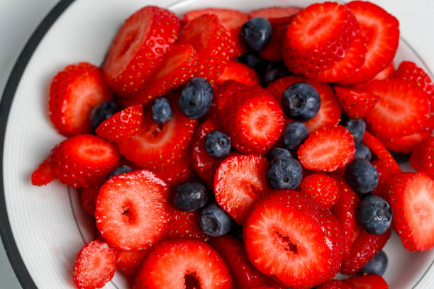 istock Bowl of  fresh strawberries and blueberries 1027190922