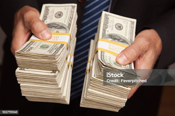 Businessman Handing Over Stacks Of Money Stock Photo - Download Image Now - Large Group Of Objects, Currency, Paper Currency