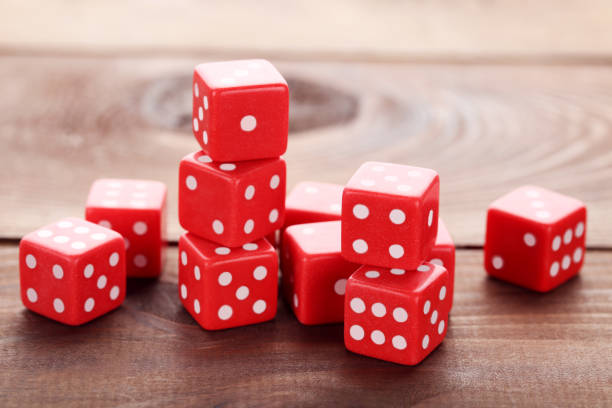 istock Red dice on brown wooden table 1027195452