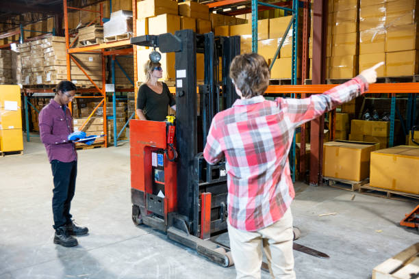 istock A supervisor takes notes as a forklift driver and coworker carry out a procedure. 1027197920