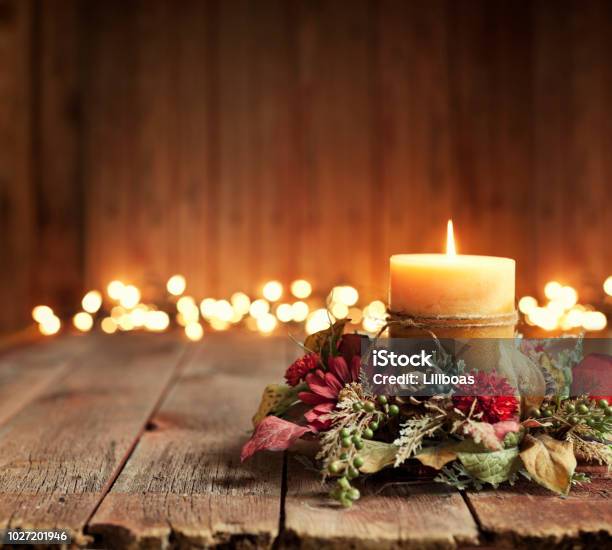 Christmas Or Thanksgiving Holiday Candle On A Wood Background Stock Photo - Download Image Now