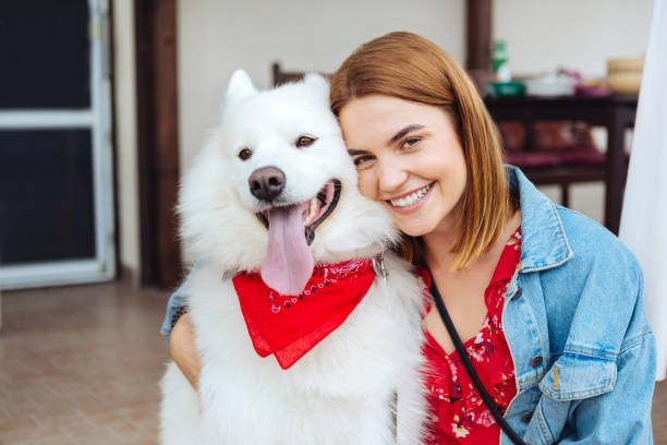 istock Dark-eyed woman smiling while hugging her cute husky 1027202562