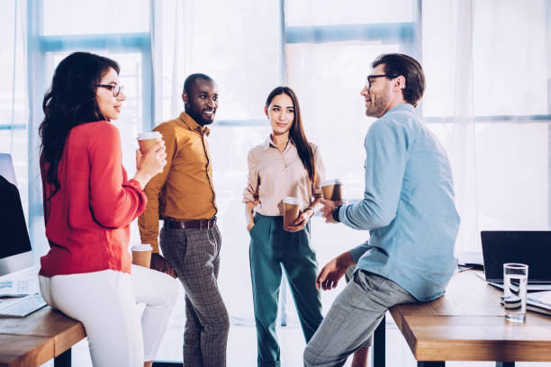 istock interracial business colleagues having conversation during coffee break in office 1027206598