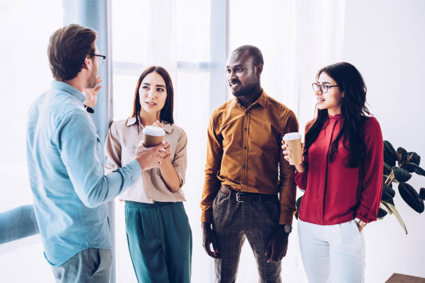istock group of multicultural business people having conversation during coffee break in office 1027206634