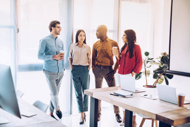 istock group of multicultural business people having conversation during coffee break in office 1027206640