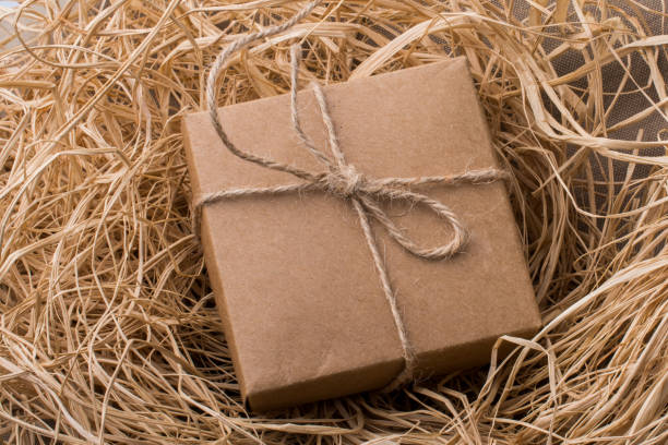 istock Gift box of brown color on a straw background 1027212488