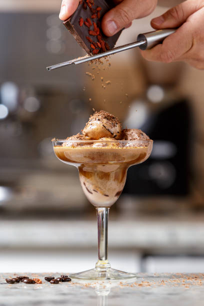 Man serving espresso ice cream into the glass