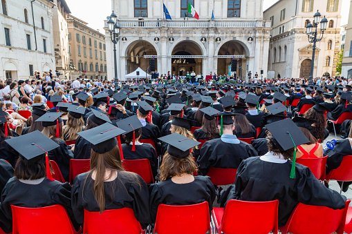 Brescia, Italy -01 July 2018:This is the conferment of the degree students of the University of Brescia in piazza della Loggia, the historical center of the city.Here we see students sat who attend the ceremony