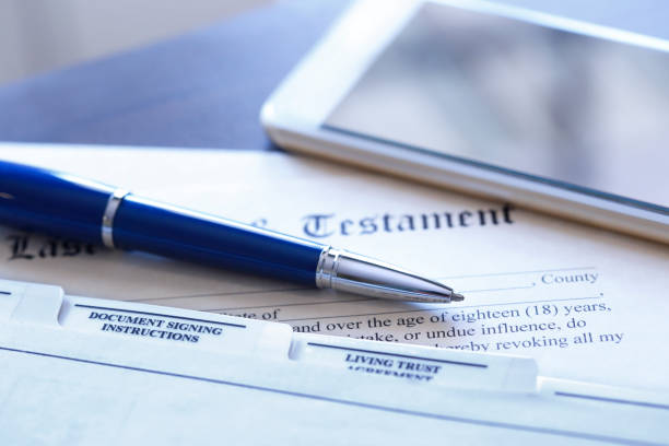 istock Ballpoint Pen And Mobile Phone Rest On Top Of Last Will And Testament Documents 1027216172