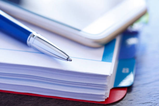 istock Ballpoint Pen And Mobile Phone Rest On Top Of Binder Of Documents 1027216264