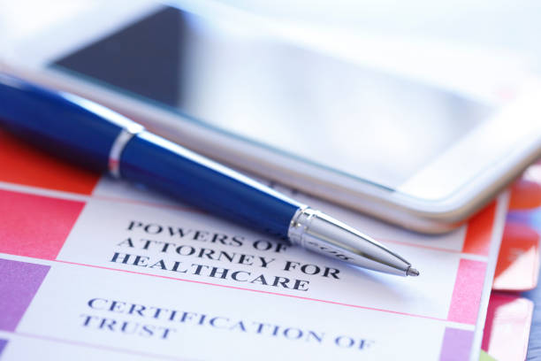 istock Ballpoint Pen And Mobile Phone Rest On Top Of Powers Of Attorney Documents 1027216270