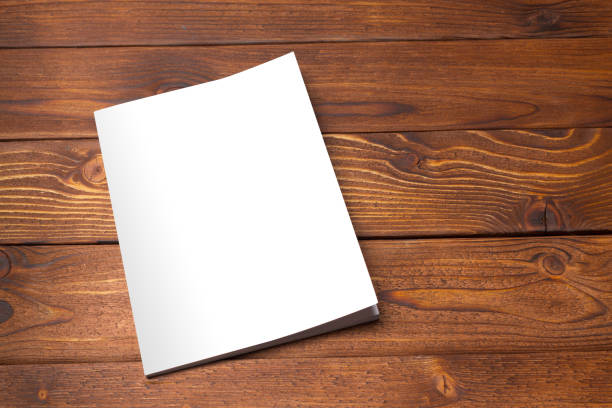 istock Blank book or magazine cover on wood background 1027219618