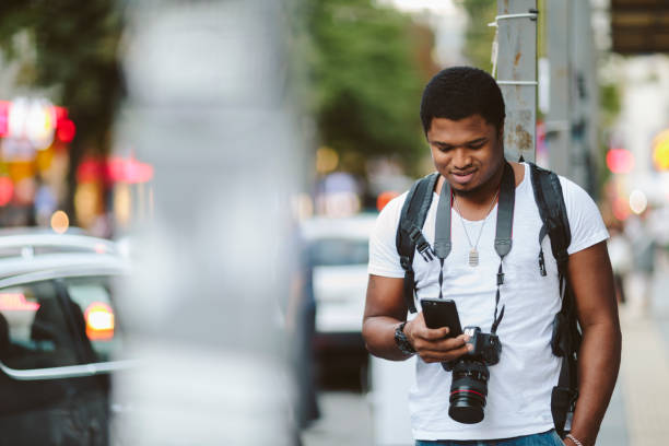 istock Male tourist using smart phone in city 1027219660