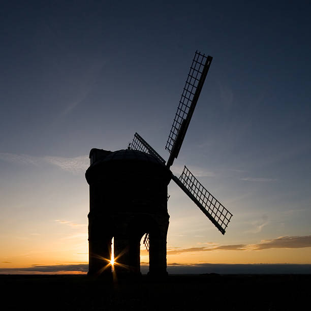 Silhouetted windmill on a hilltop at sunset  chesterton photos stock pictures, royalty-free photos & images