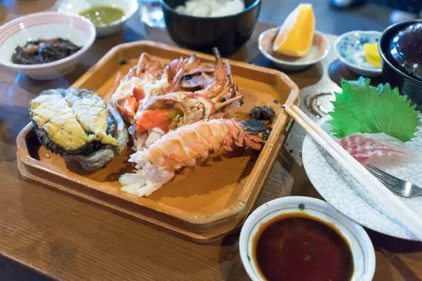 Photo of Grilled Japanese spiny lobster and fresh large abalones , popular items in high-class Japanese cuisine , Mie , Japan