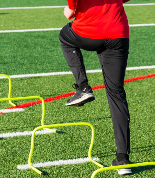 istock Athlete stepping over yellow mini hurdles 1027229538