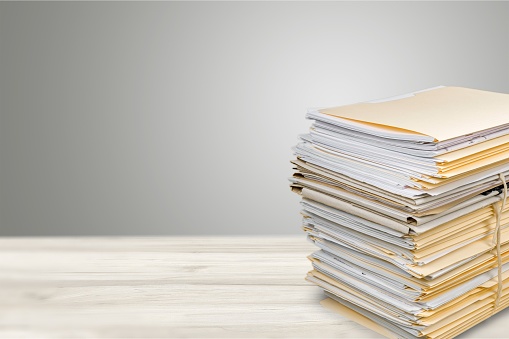 Stack of documents in folders isolated on white