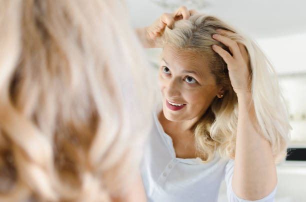 istock Happy woman cheking her hair 1027241574