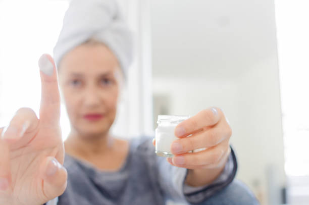 istock Woman holding face cream 1027241730