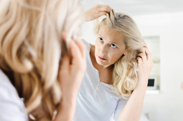 istock Woman looking for some grey hair 1027241752