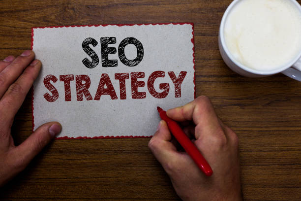 istock Word writing text Seo Strategy. Business concept for Techniques and tactics to increase the visitors of a website Man holding marker communicating ideas piece paper wooden table cup coffee 1027242016