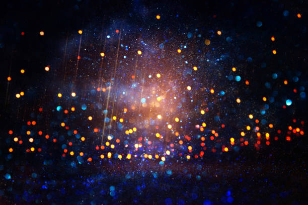 istock glitter vintage lights background. black, blue, purple and gold. de-focused. 1027242338