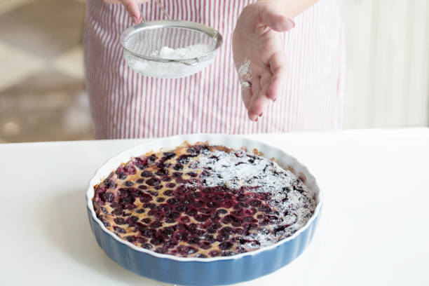 istock Clafoutis cherry pie. preparation of a French pie with cherries 1027242832