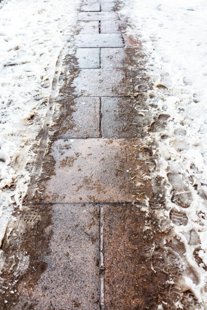istock Dirty wet snow in the pavement 1027245732