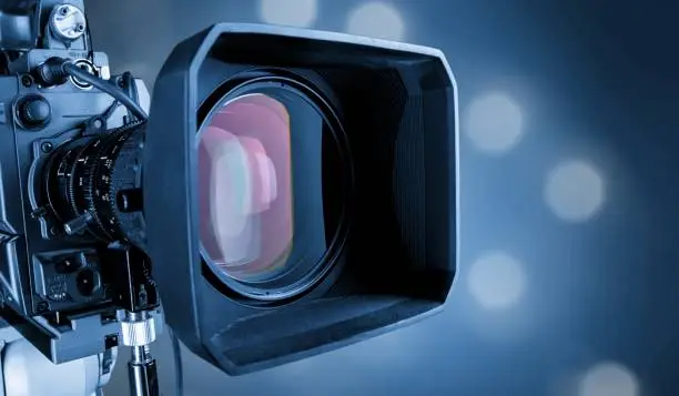 Close-up of a television camera lens on blurred background, bokeh