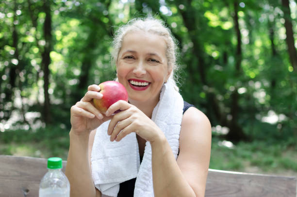 istock Senior woman holding aplle 1027250048