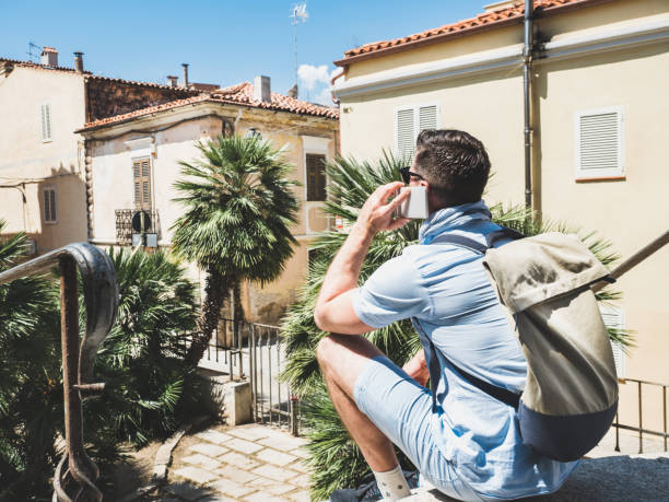 istock Stylish, attractive traveler with phone sitting on stairs 1027253076
